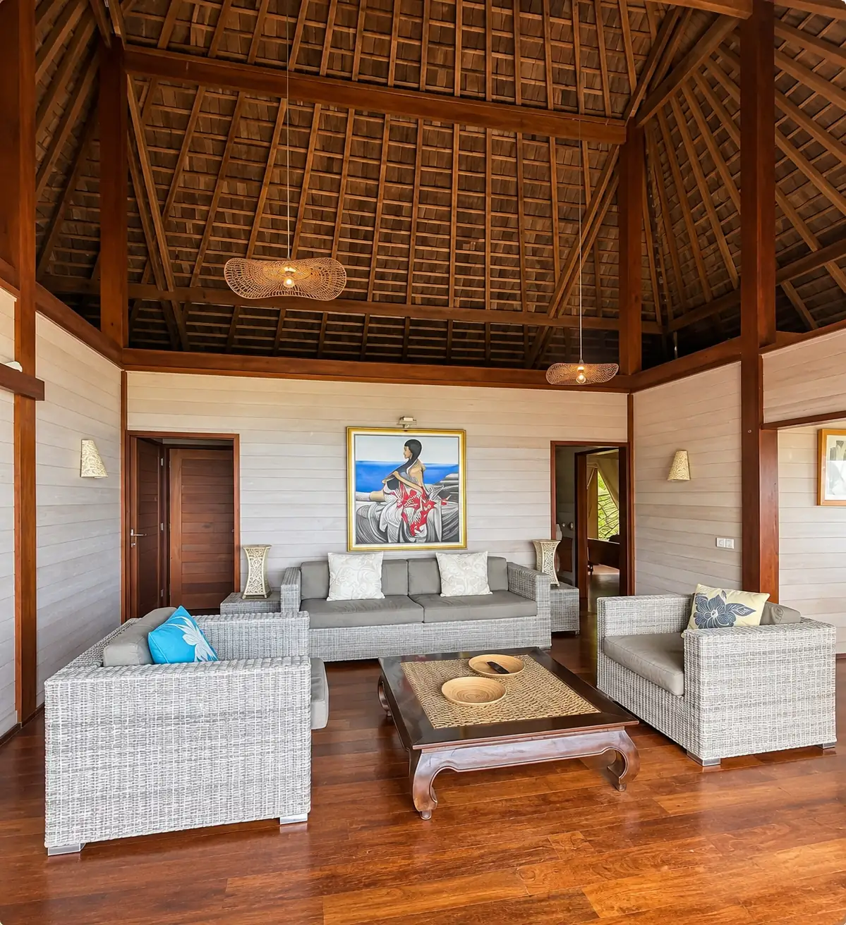 Le salon, ses fauteuils en rotin et sa charpente en pandanus